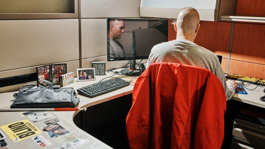 blind employee seated at dedicated workstation